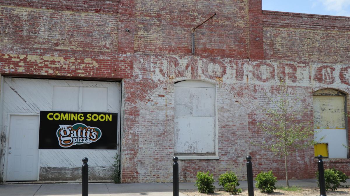 A Mr. Gatti's Pizza 'Coming Soon' sign appears on 1st Avenue building