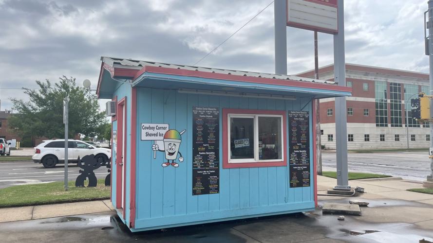 A bowl filled with blue ice cream next to a window