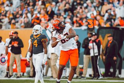 Orange script helmets highlight Cowboys uniforms against West