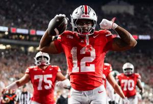 Ohio State Buckeyes running back CJ Donaldson (12) reacts after making it to the endzone during the second half of the NCAA football game against the Ohio State Buckeyes at Ohio Stadium on Sept. 13, 2025. The touchdown was overturned by replay, but O