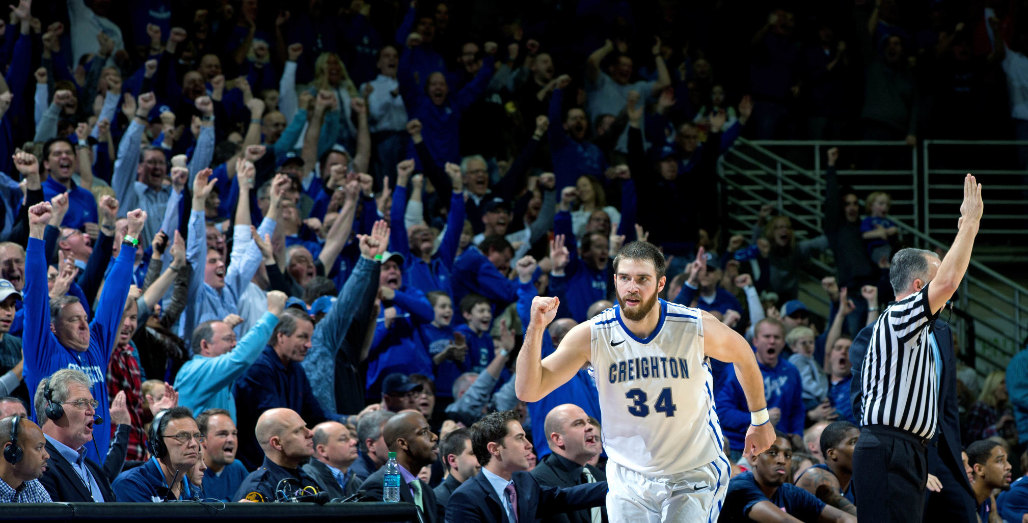 Former Creighton guard Mike Caruso watching his son Alex help