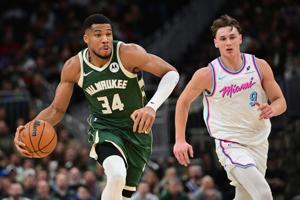 Jan 23, 2025; Milwaukee, Wisconsin, USA; Milwaukee Bucks forward Giannis Antetokounmpo (34) drives for the basket against Miami Heat guard Pelle Larsson (9) in the third quarter at Fiserv Forum. Mandatory Credit: Benny Sieu-Imagn Images