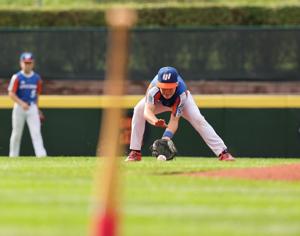 Shortstop Leo Feltner of Hamilton, Ohio, (Great Lakes Region) fields the ground ball and throws out the runner at first base