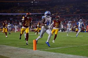 Nov 9, 2025; Landover, Maryland, USA; Detroit Lions running back Jahmyr Gibbs (0) runs in for a touchdown past Washington Commanders safety Quan Martin (20) and cornerback Jonathan Jones (31) during the fourth quarter at Northwest Stadium. Mandatory 