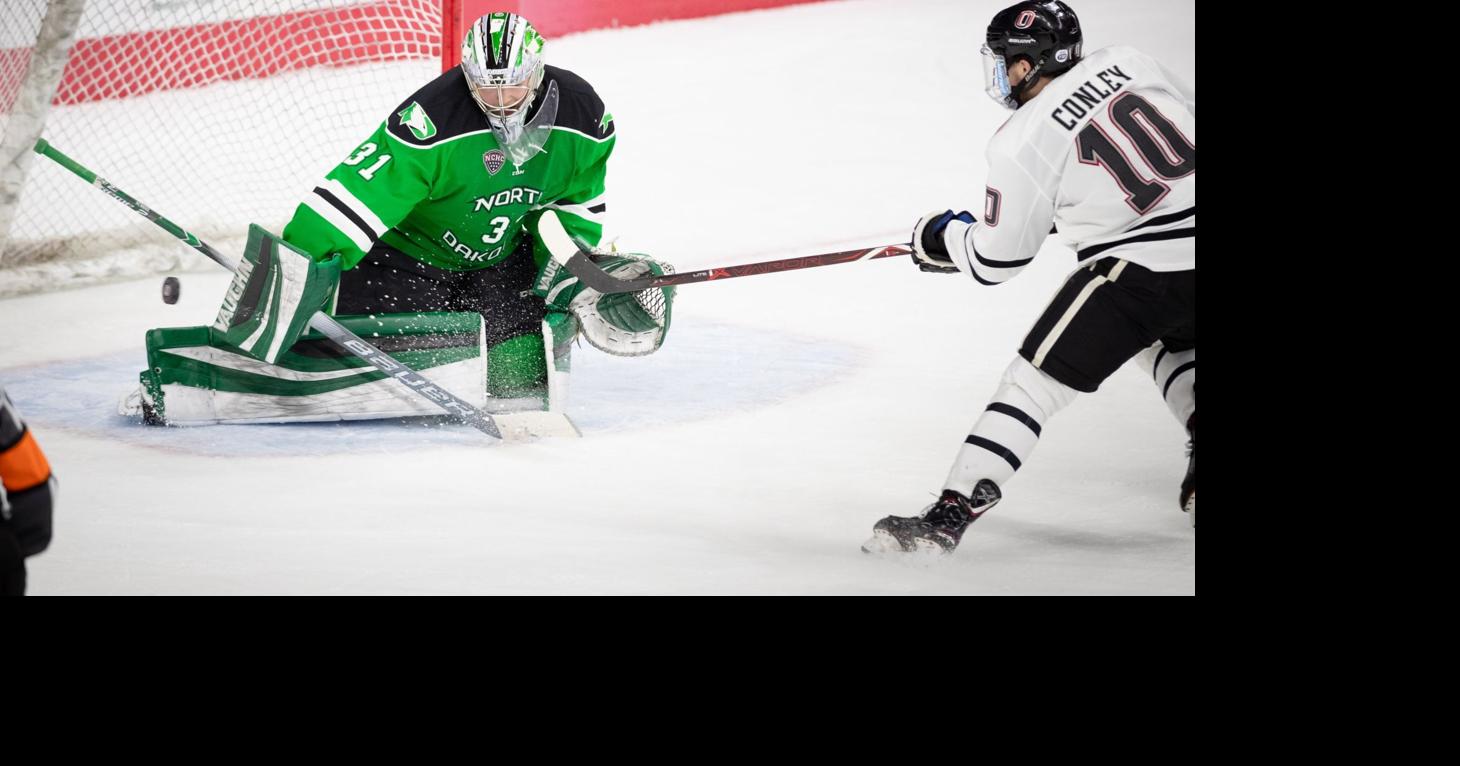 Two North Dakota hockey players kneel during national anthem