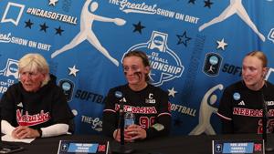 Nebraska's Rhonda Revelle and players after NCAA Super Regional game 1 win over Oklahoma State
