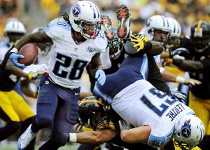 Tennessee Titans running back Chris Johnson (28) speeds past the Pittsburgh Steelers defense during the second quarter at Heinz Field in Pittsburgh on Sept. 8, 2013.