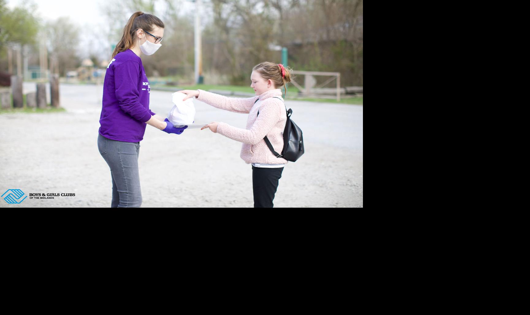 Carter Lake Club staff handing out meals to a Club member.jpg