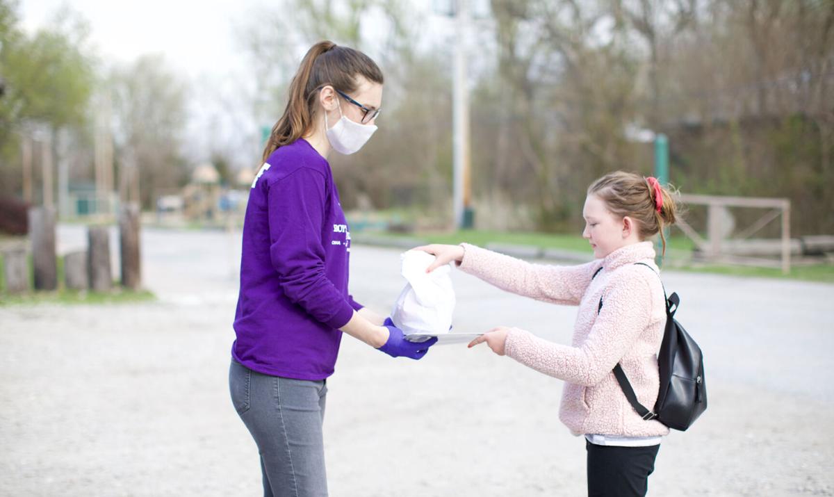 Carter Lake Club staff handing out meals to a Club member.jpg