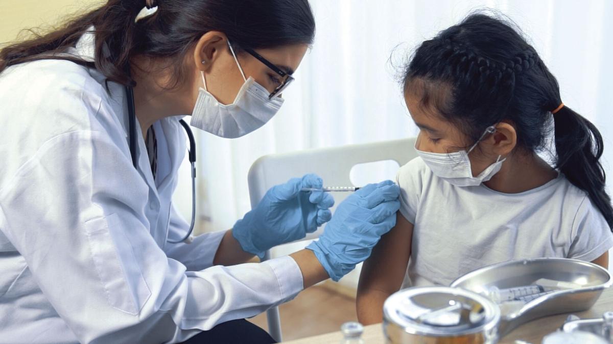 School girl visits skillful doctor at hospital for vaccination