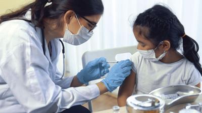 School girl visits skillful doctor at hospital for vaccination