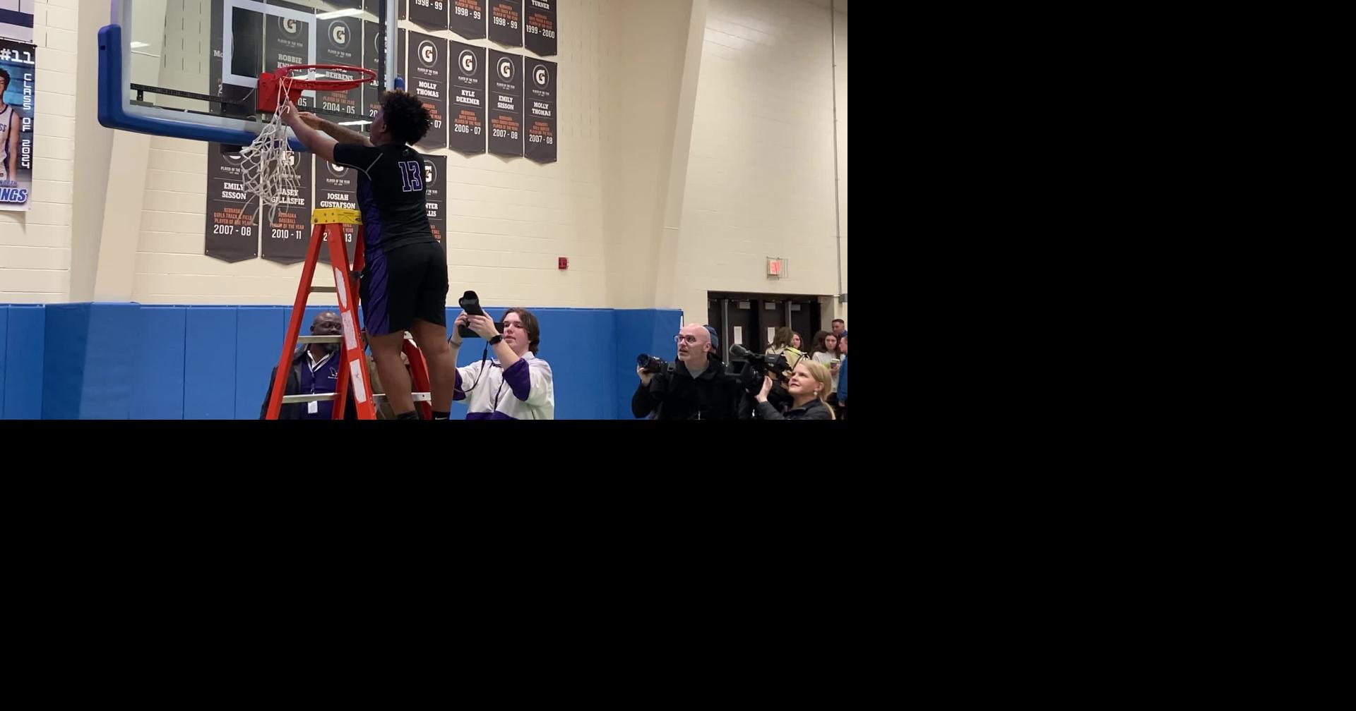 Omaha Central’s Inia Jones cuts down the net after winning district final