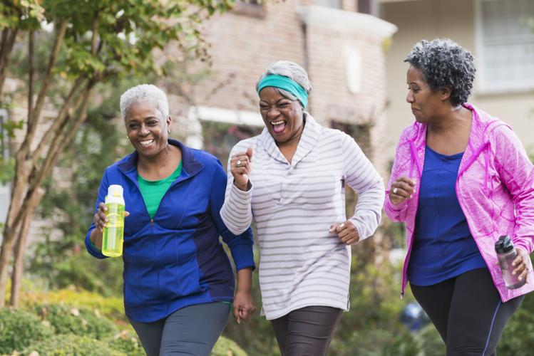 Three senior black women exercising together