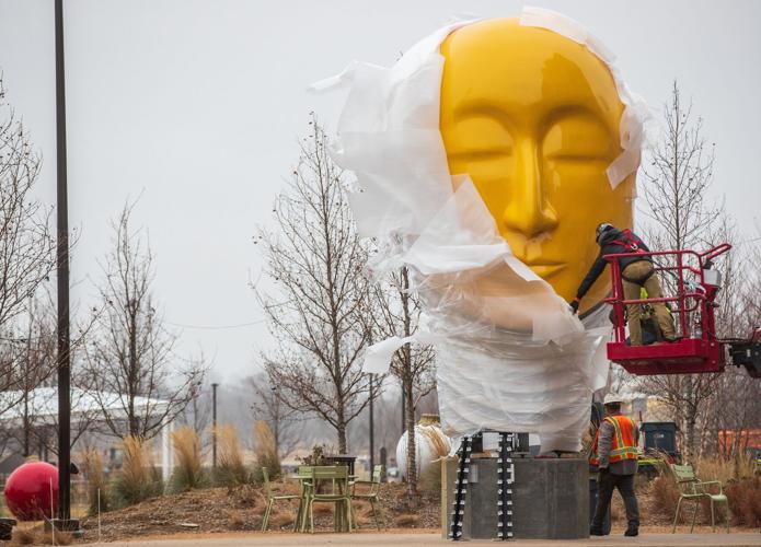 Eye-catching bronze head sculpture by Omaha artist Jun Kaneko installed  downtown