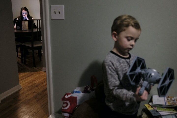 Elena Williams worked on some MCTC school work as her son, Parker, 4, plaid with a Star Wars toy in his room.