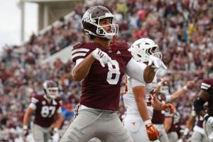 Oct 25, 2025; Starkville, Mississippi, USA; Mississippi State Bulldogs tight end Seydou Traore (8) does the “horns down” gesture after a touchdown during the second quarter against the Texas Longhorns at Davis Wade Stadium at Scott Field. Mandatory C