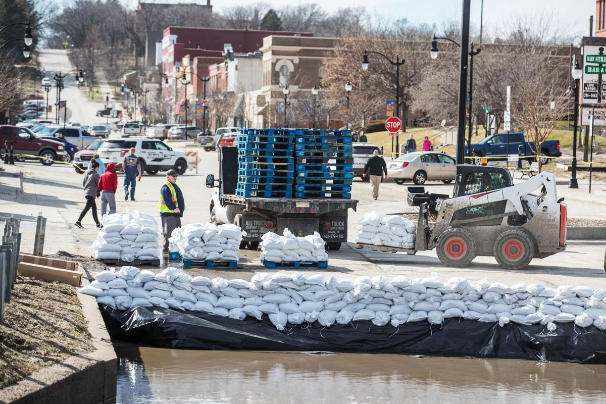 In Plattsmouth as the river rises tired, dry and sandbagging to save