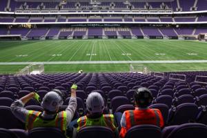 From left, Pat Ryan, Edward Keegan and Bryan Schabel sit at the 50- yard line in the 100 level seats at Northwestern University’ s nearly finished Ryan Field on Sept. 14, 2026, in Evanston, Ill..