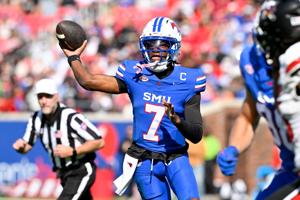 SMU quarterback Kevin Jennings (7) throws the ball during his team's game against Louisville at Gerald J. Ford Stadium.
