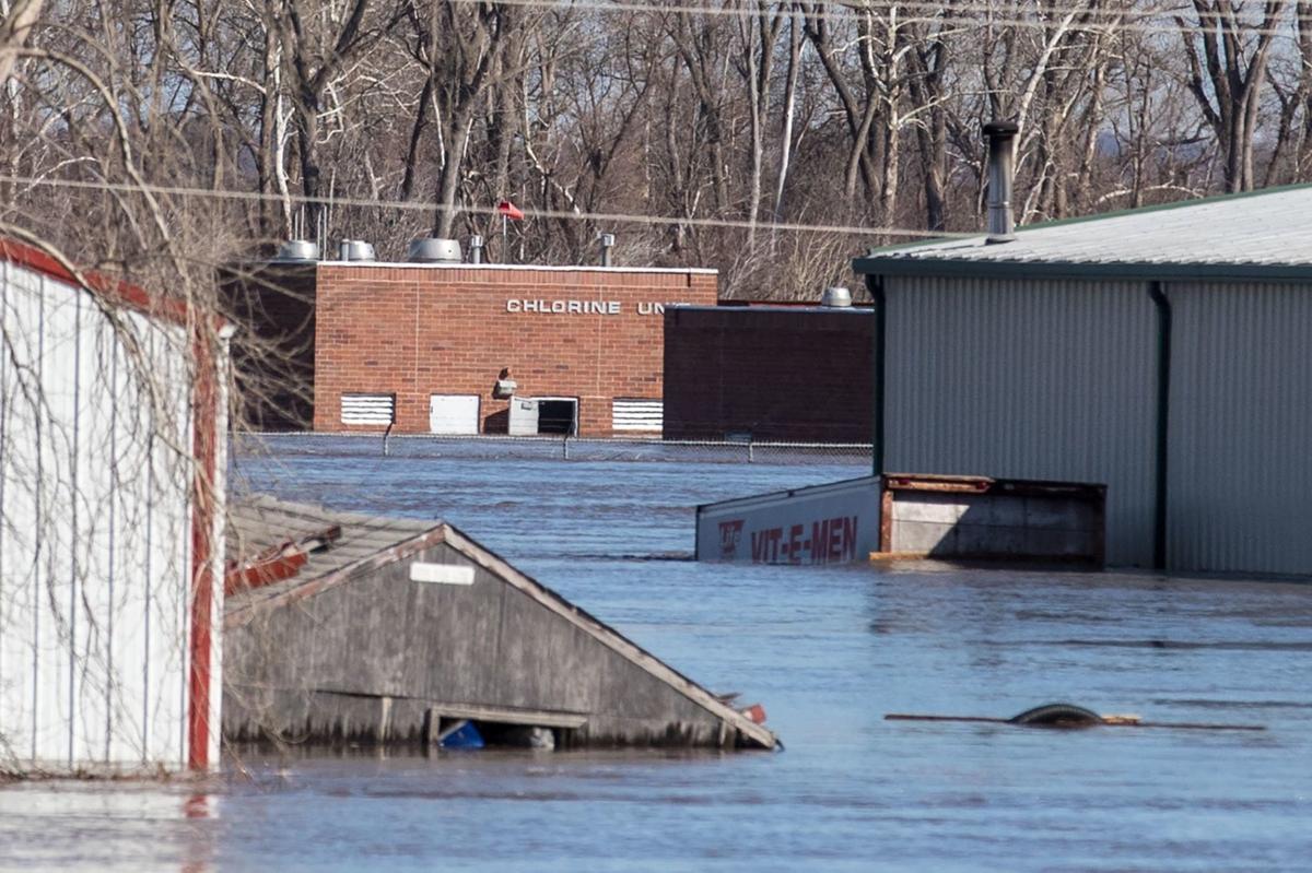 In Plattsmouth as the river rises tired, dry and sandbagging to save