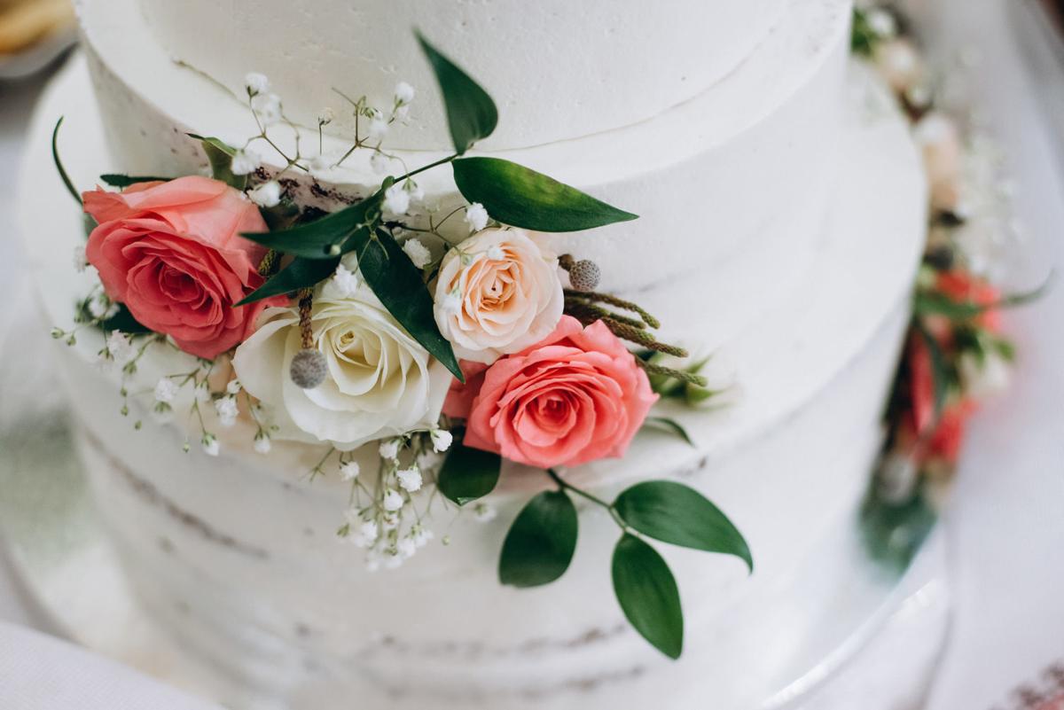 wedding cake with red and white flowers