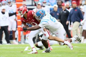 Nov 2, 2024; Fayetteville, Arkansas, USA; Arkansas Razorbacks quarterback Taylen Green (10) is injured on a tackle by Ole Miss Rebels nose tackle Zxavian Harris (51) during the first quarter at Donald W. Reynolds Razorback Stadium. Mandatory Credit: 