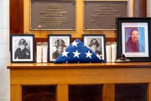 A mantle hold photos firefighters who lost their lives from the Sept. 11, 2001 attack during an annual event where retired