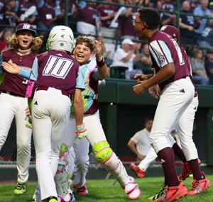 Anthony Sullivan of Bridgewater, MA (New England Region) hits a home run against Bayonne, NJ (Metro Region) and is congratulated