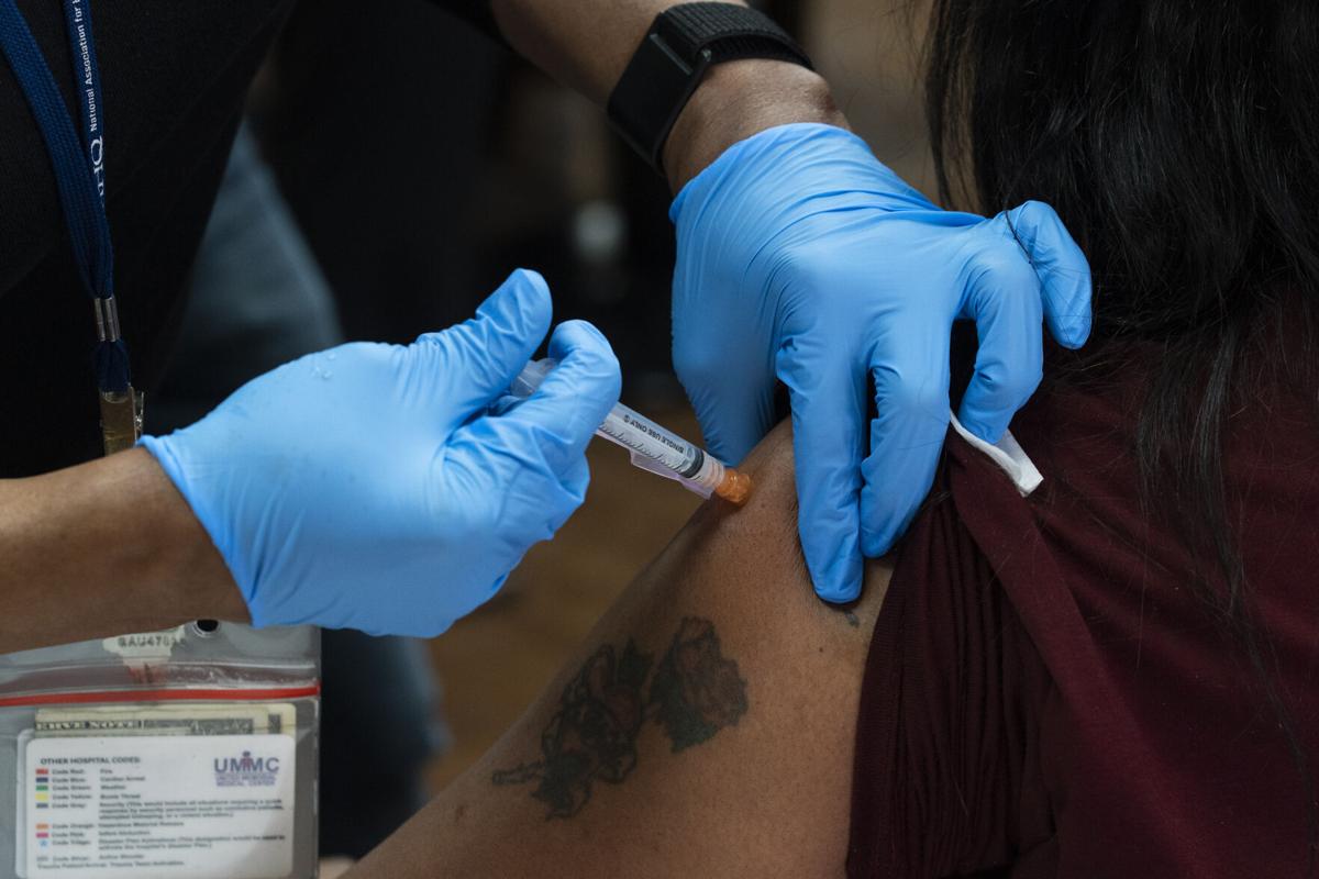 A health care worker receives the Moderna COVID-19 vaccine at the United Memorial Medical Center on December 21, 2020, in Houston, Texas. (copy)