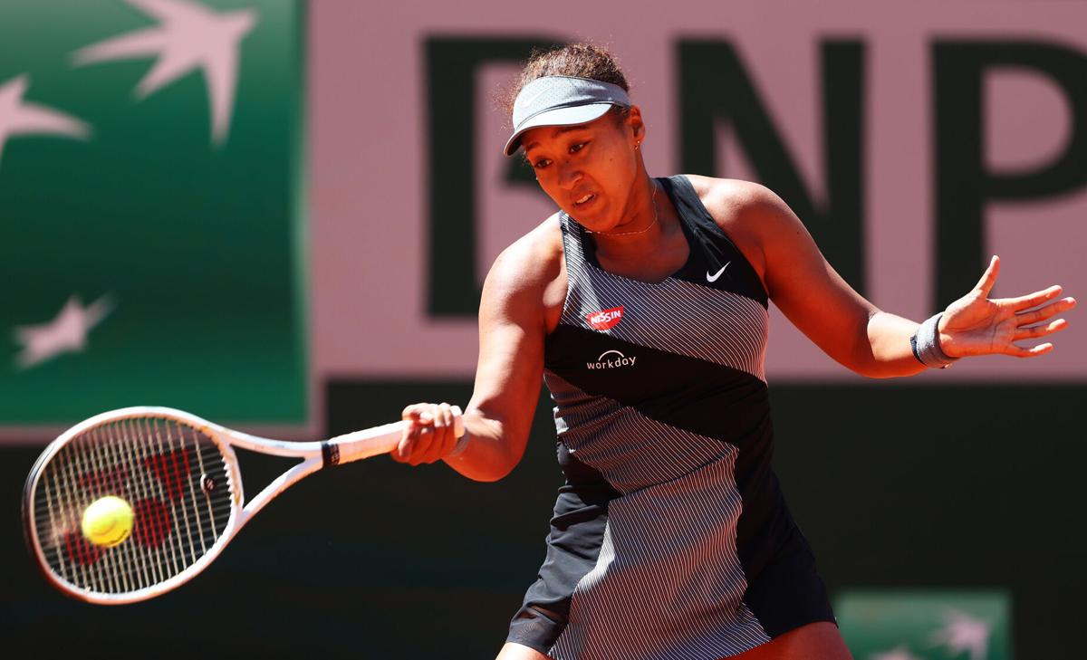 Naomi Osaka of Japan plays a forehand in her First Round match against Patricia Maria Tig of Romania during Day One of the 2021 French Open at Roland Garros on May 30, 2021 in Paris, France.