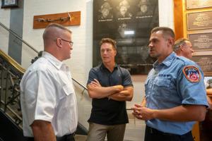 Retired New York Mets player Todd Zeile chats with New York firefighters during an annual event where retired players from the