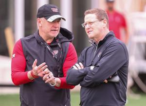 Texas Tech director of athletics Kirby Hocutt (right) speaks with Joey McGuire during spring practice, Tuesday, April 1, 2025, at the Womble Football Center.
