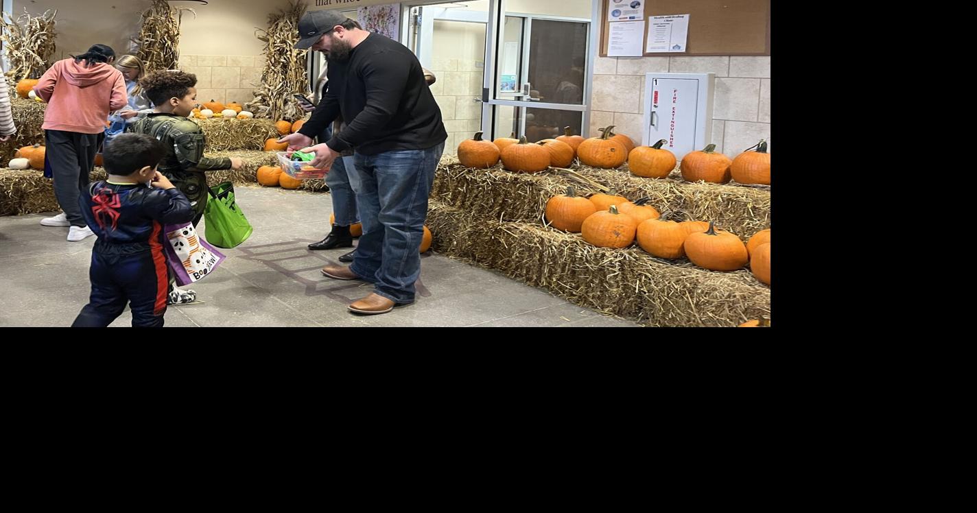 Omaha children experiencing homelessness trick or treat, paint pumpkins