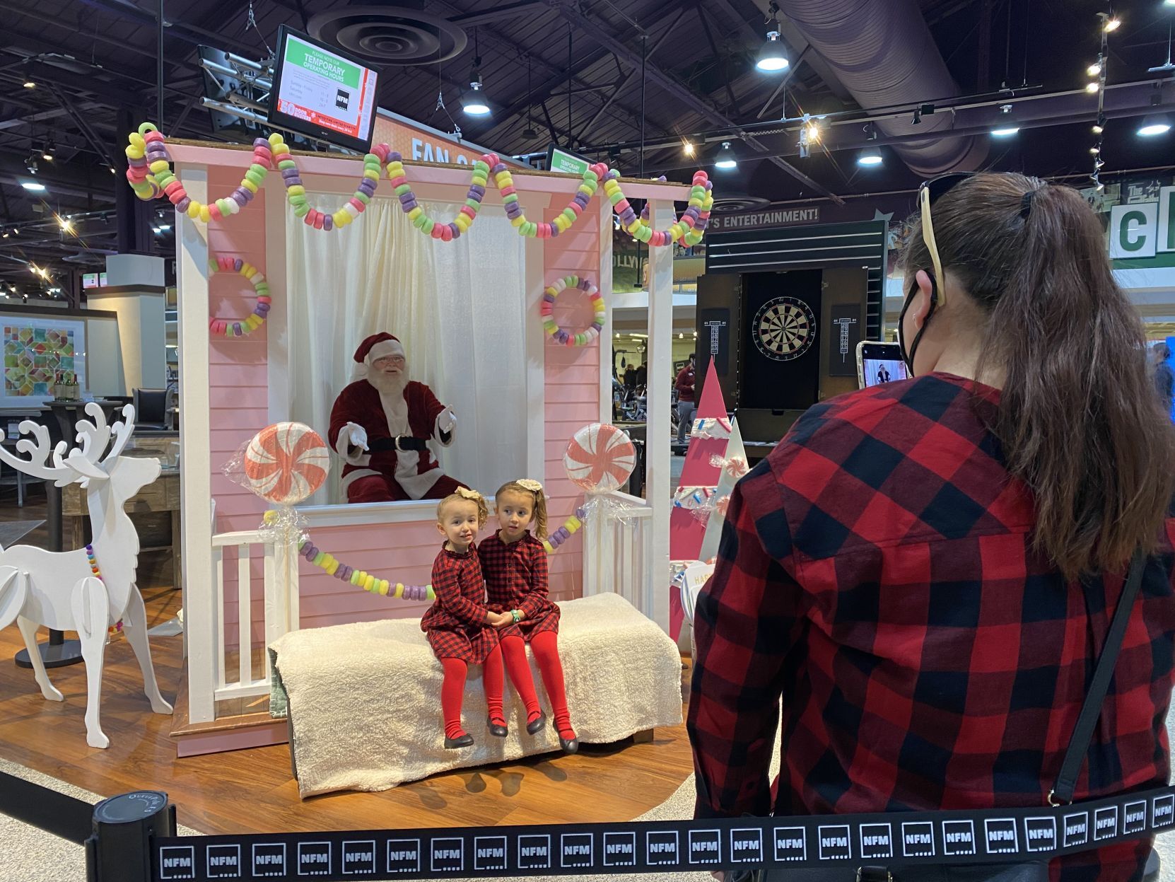 Santa keeps his distance as kids visit him at Nebraska Furniture Mart