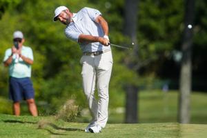 Scottie Scheffler hits an approach shot on the 16th hole during the third round of the FedEx St. Jude Championship at TPC