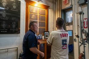 Retired New York Mets third basement David Wright chats with a firefighter during an annual event where retired players from the