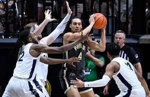 Feb 1, 2023; West Lafayette, Indiana, USA; Purdue Boilermakers forward Trey Kaufman-Renn (4) looks to keep the ball away from Penn State Nittany Lions defenders during the first half at Mackey Arena. Mandatory Credit: Marc Lebryk-USA TODAY Sports