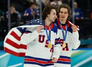 Feb 22, 2026; Milan, Italy; Quinn Hughes (43) of the United States and Jack Hughes (86) of the United States celebrate after defeating Canada in the men's ice hockey gold medal game during the Milano Cortina 2026 Olympic Winter Games at Milano Santag