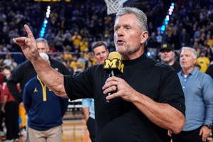 Michigan football head coach Kyle Whittingham speaks as he is being introduced on the floor during the first half between
