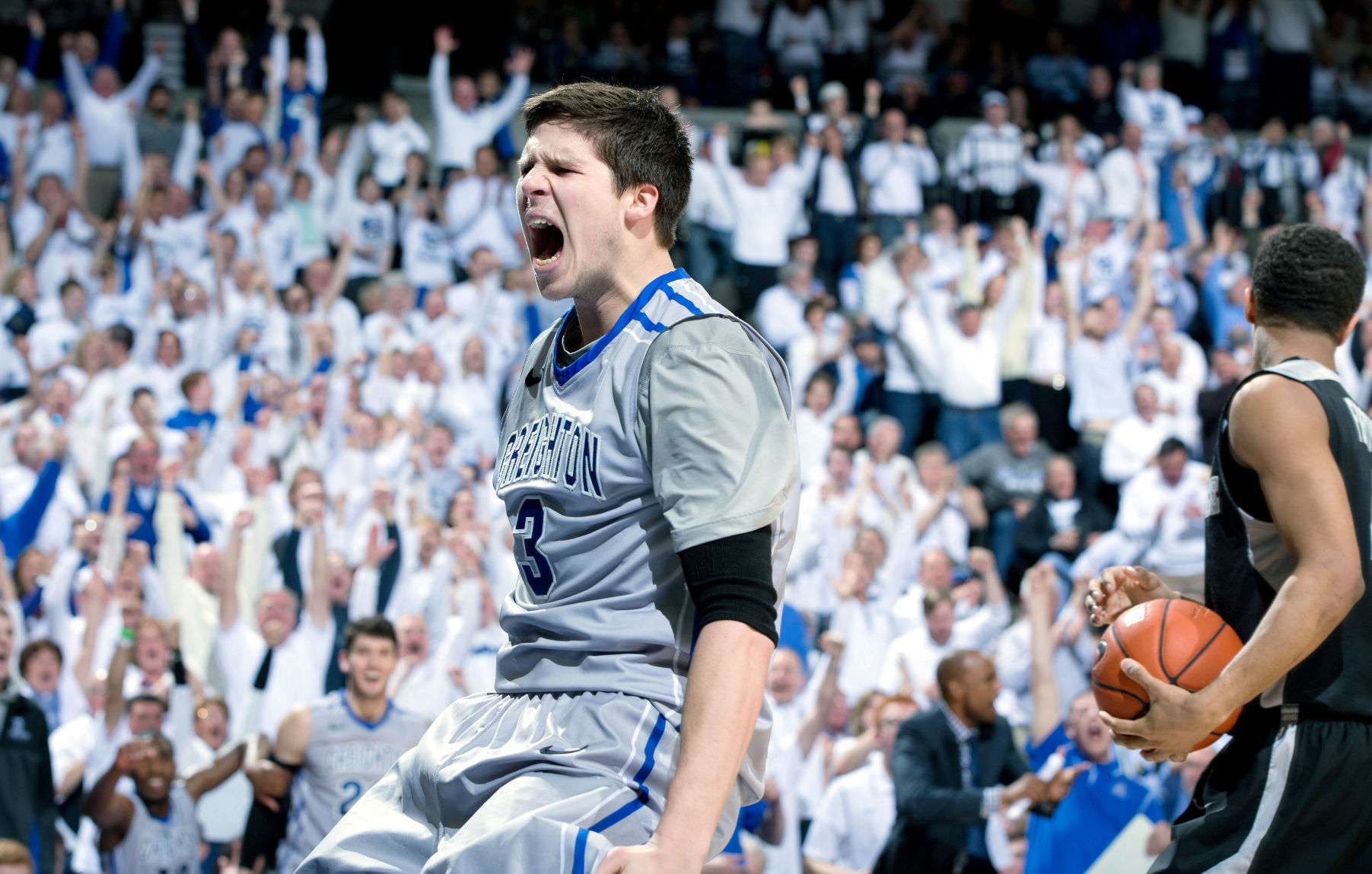 Former Creighton guard Mike Caruso watching his son Alex help