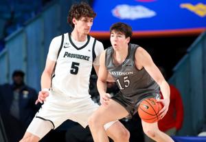 Nov 28, 2024; Paradise Island, Bahamas, BHS; Davidson Wildcats forward Sean Logan (15) dribbles as Providence Friars center Anton Bonke (5) defends during the first half at the Imperial Arena at the Atlantis Resort. Mandatory Credit: Kevin Jairaj-Ima