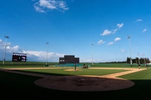 The grounds crew works on the field as the Clinton and Western Dubuque varsity baseball teams warm up June 17, 2026 at the Field of Dreams Ballpark in Dyersville, Iowa.
