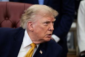 U.S. President Donald Trump signs an executive order in the Oval Office at the White House in Washington