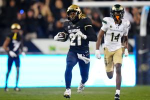 Colorado Buffaloes safety Shilo Sanders runs for a touchdown after making an interception against the Colorado State Rams during the first half at Folsom Field.