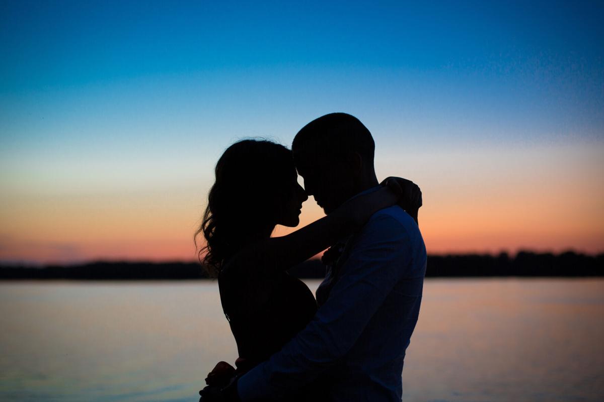 Silhouettes of a couple in love romance at sunset