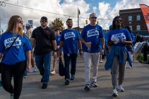 UAW President Shawn Fain, middle, walks alongside union members during the Detroit Labor Day parade in Detroit on Monday, Sept.