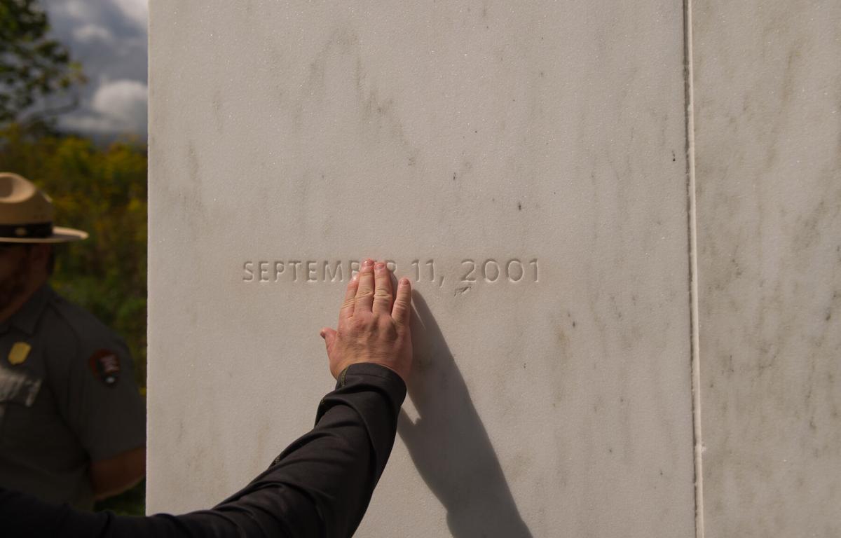 A visitor traces the date etched in a marble slab on the Wall of Names at the Flight 93 National Memorial before the 15th Anniversary of the September 11 terrorist attacks, September 11, 2016 in Shanksville, Pennsylvania.