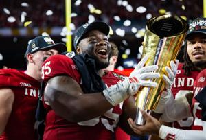 Jan 19, 2026; Miami Gardens, FL, USA; Indiana Hoosiers defensive lineman Tyrique Tucker (95) celebrates with the trophy after defeating the Miami Hurricanes in the College Football Playoff National Championship game at Hard Rock Stadium. Mandatory Cr