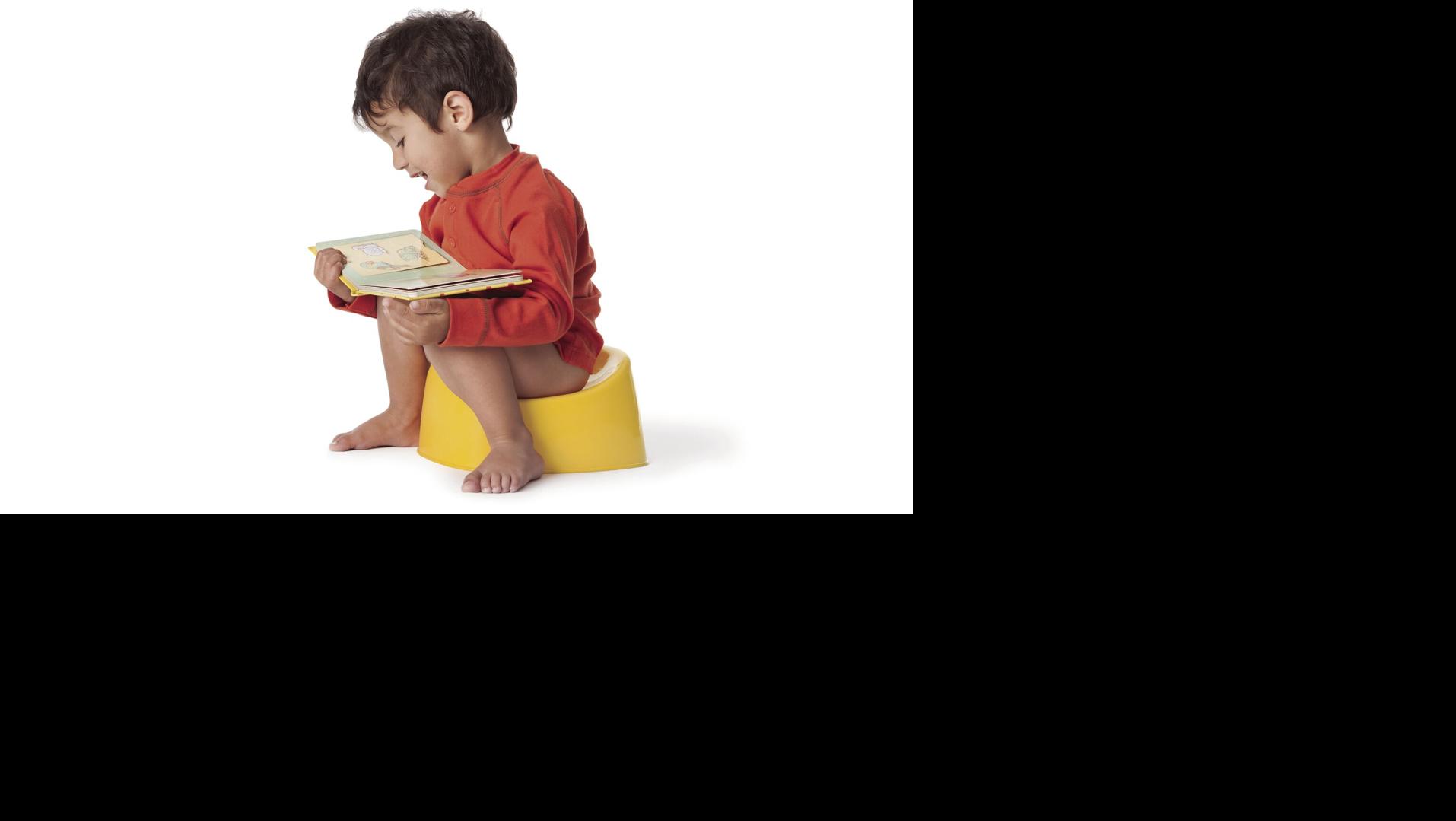 Toddler boy sitting on a potty
