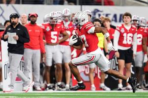 Ohio State Buckeyes wide receiver Carnell Tate (17) runs after a catch during the Cotton Bowl at AT&T Stadium in Arlington,